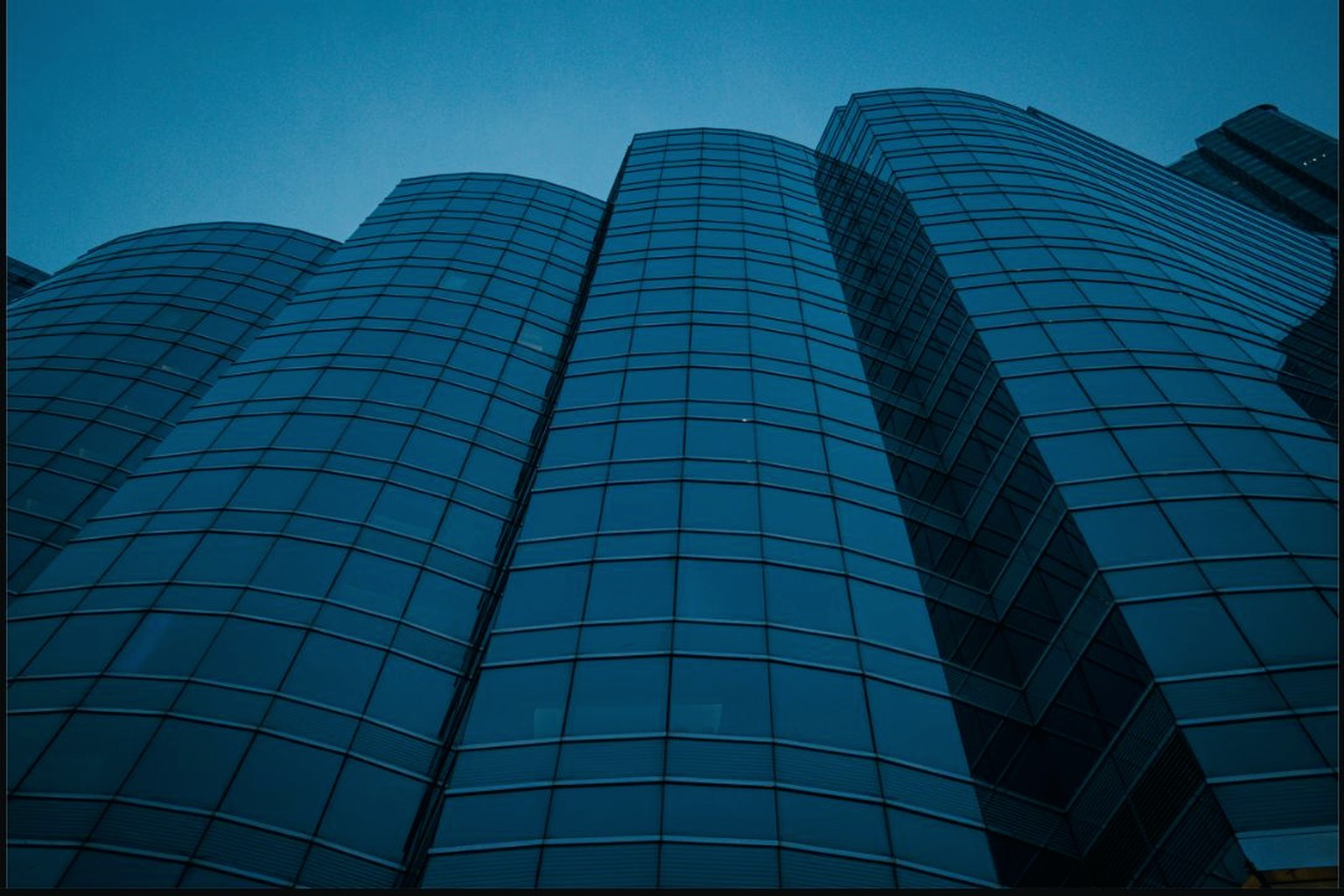 Glass office towers seen from below